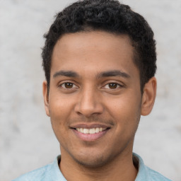 Joyful latino young-adult male with short  brown hair and brown eyes