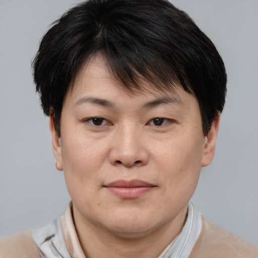 Joyful asian adult female with short  brown hair and brown eyes