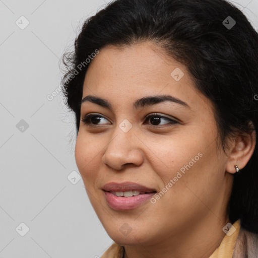 Joyful latino young-adult female with long  brown hair and brown eyes