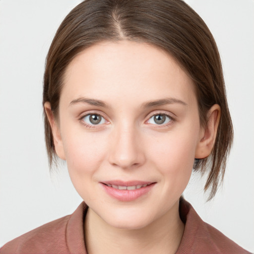 Joyful white young-adult female with medium  brown hair and blue eyes