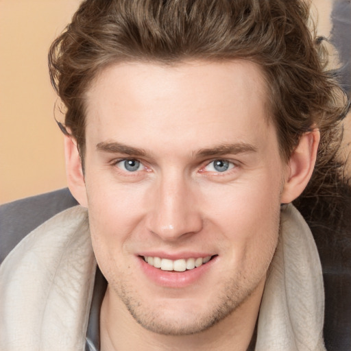 Joyful white young-adult male with medium  brown hair and grey eyes