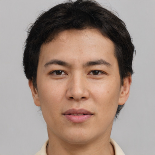 Joyful asian young-adult male with short  brown hair and brown eyes
