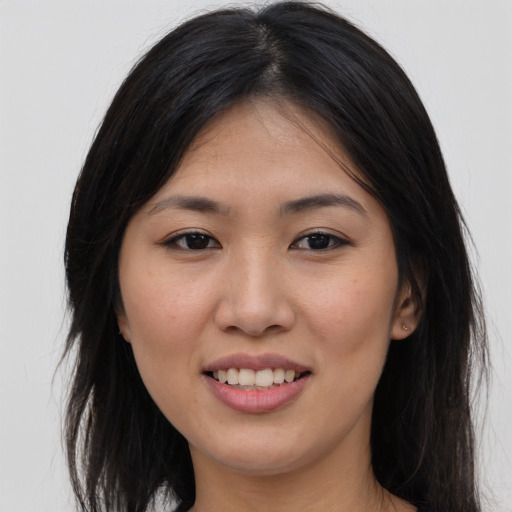 Joyful asian young-adult female with long  brown hair and brown eyes