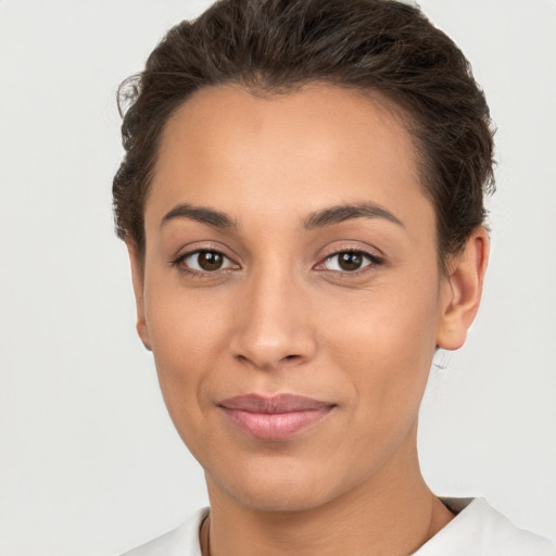 Joyful white young-adult female with short  brown hair and brown eyes