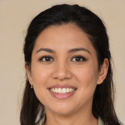 Joyful latino young-adult female with long  brown hair and brown eyes