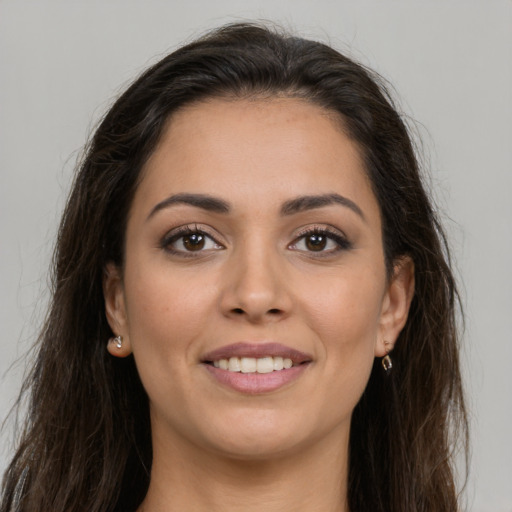 Joyful white young-adult female with long  brown hair and brown eyes