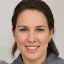 Joyful white adult female with medium  brown hair and brown eyes