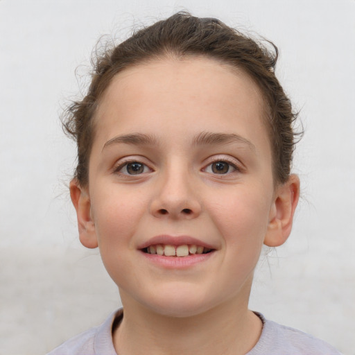 Joyful white child female with short  brown hair and brown eyes