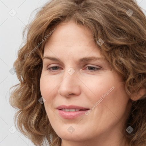 Joyful white young-adult female with medium  brown hair and green eyes