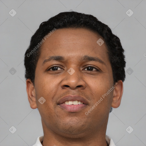 Joyful black young-adult male with short  brown hair and brown eyes