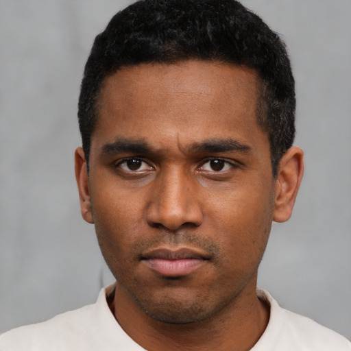 Neutral latino young-adult male with short  black hair and brown eyes