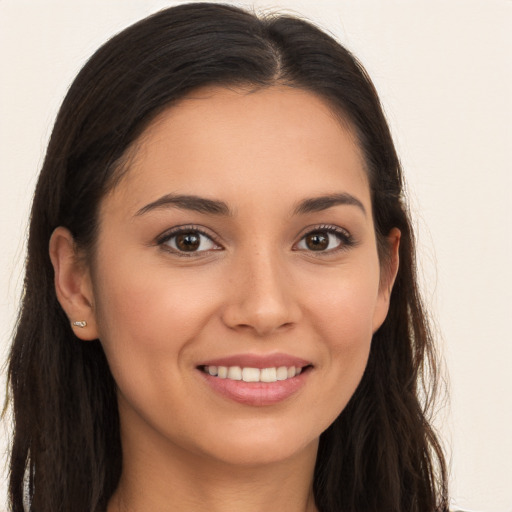 Joyful white young-adult female with long  brown hair and brown eyes