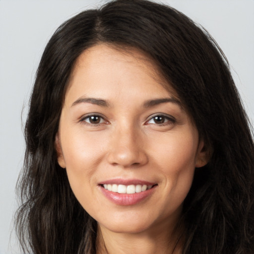 Joyful white young-adult female with long  brown hair and brown eyes