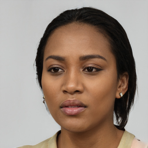 Neutral black young-adult female with medium  black hair and brown eyes