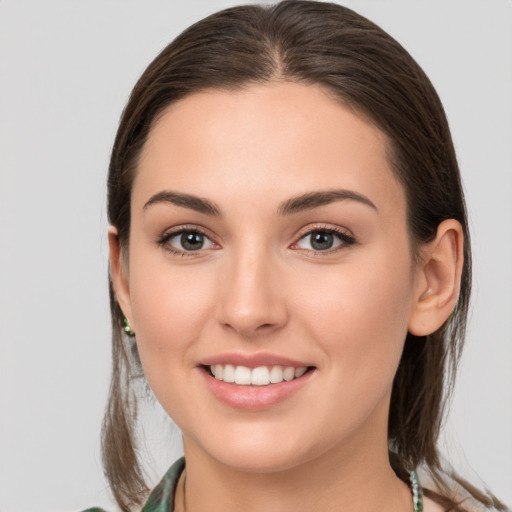 Joyful white young-adult female with medium  brown hair and brown eyes