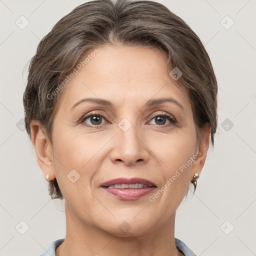 Joyful white adult female with short  brown hair and grey eyes