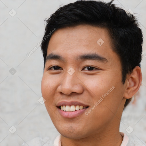 Joyful asian young-adult male with short  brown hair and brown eyes