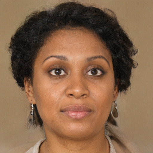 Joyful black young-adult female with medium  brown hair and brown eyes
