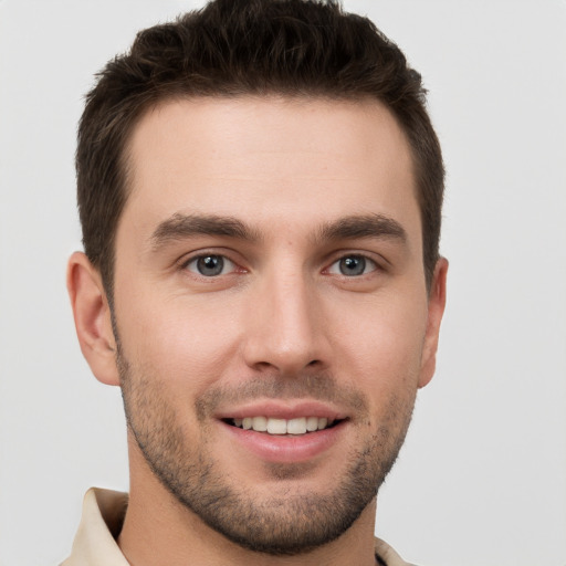 Joyful white young-adult male with short  brown hair and brown eyes