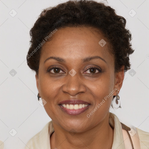 Joyful black adult female with short  brown hair and brown eyes