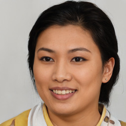 Joyful asian young-adult female with medium  brown hair and brown eyes