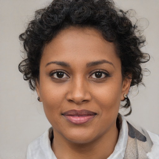 Joyful black young-adult female with medium  brown hair and brown eyes