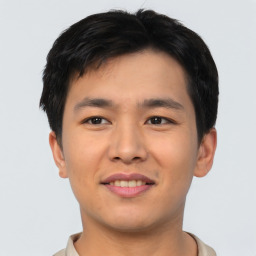 Joyful asian young-adult male with short  black hair and brown eyes