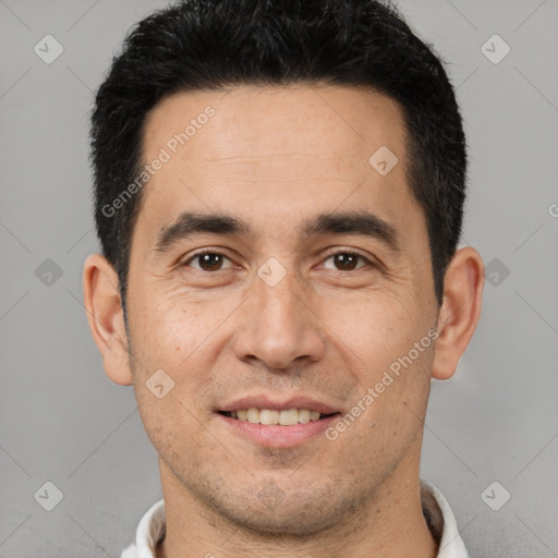 Joyful white young-adult male with short  black hair and brown eyes