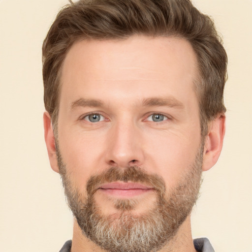 Joyful white adult male with short  brown hair and grey eyes