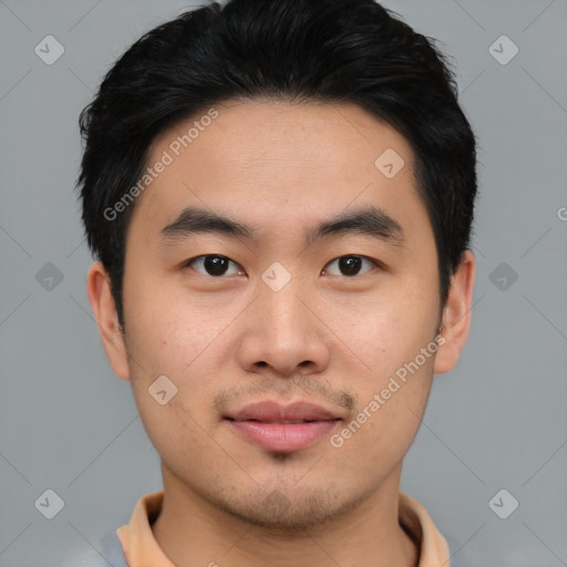 Joyful asian young-adult male with short  black hair and brown eyes