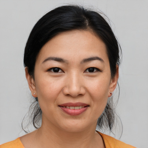 Joyful white young-adult female with medium  black hair and brown eyes