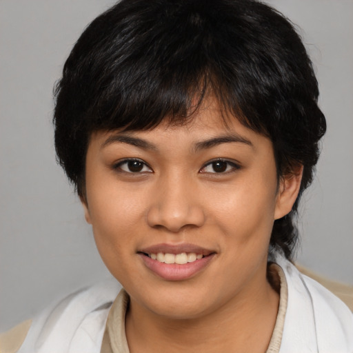 Joyful asian young-adult female with medium  brown hair and brown eyes