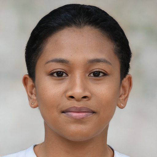 Joyful latino young-adult female with short  brown hair and brown eyes