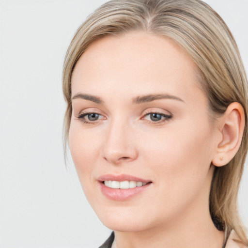 Joyful white young-adult female with long  brown hair and blue eyes