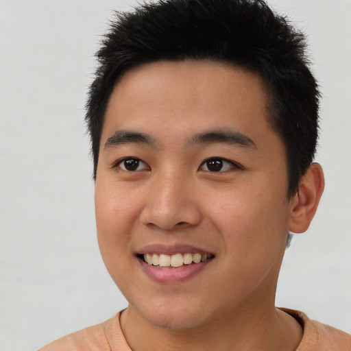 Joyful asian young-adult male with short  brown hair and brown eyes