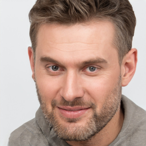 Joyful white adult male with short  brown hair and brown eyes