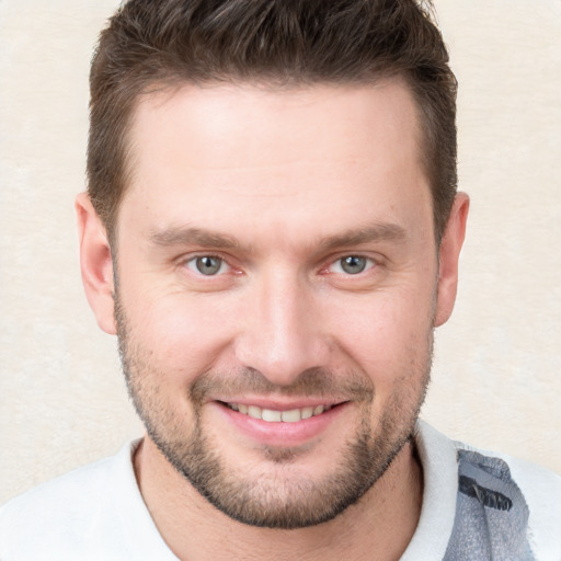 Joyful white young-adult male with short  brown hair and grey eyes