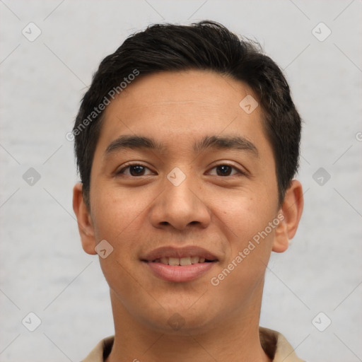 Joyful latino young-adult male with short  black hair and brown eyes