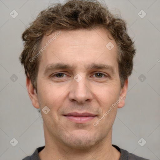 Joyful white adult male with short  brown hair and grey eyes