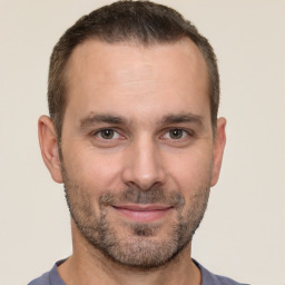 Joyful white adult male with short  brown hair and brown eyes