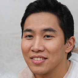 Joyful asian young-adult male with short  brown hair and brown eyes