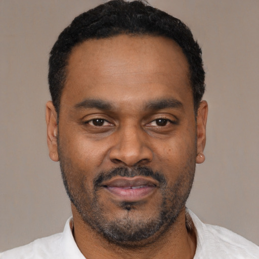 Neutral latino adult male with short  black hair and brown eyes