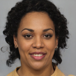 Joyful black adult female with medium  brown hair and brown eyes