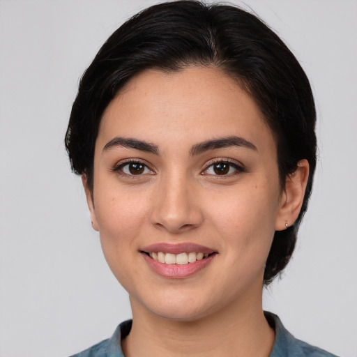 Joyful white young-adult female with medium  black hair and brown eyes