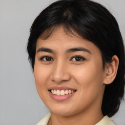 Joyful asian young-adult female with medium  brown hair and brown eyes