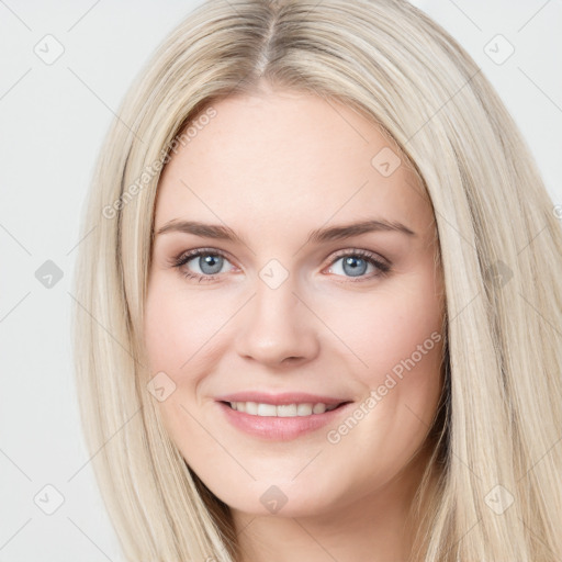 Joyful white young-adult female with long  brown hair and blue eyes