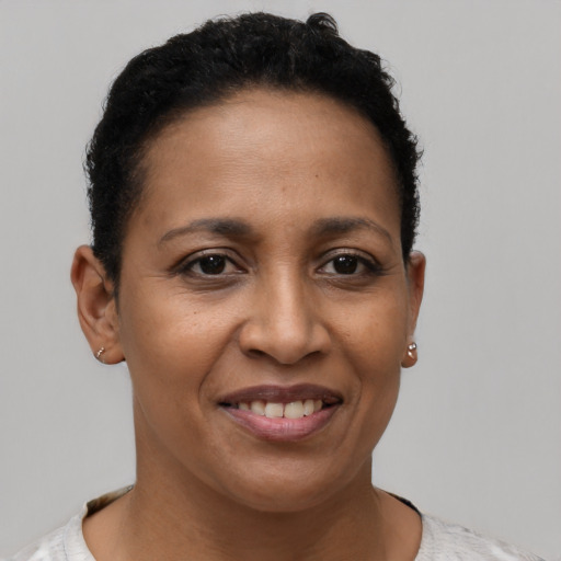 Joyful latino young-adult female with short  brown hair and brown eyes