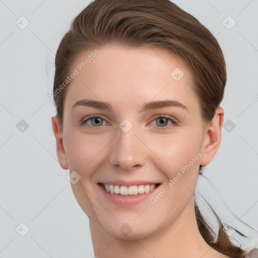 Joyful white young-adult female with long  brown hair and grey eyes