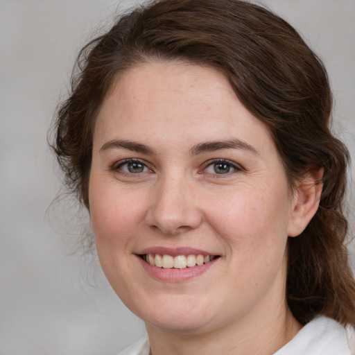 Joyful white young-adult female with medium  brown hair and brown eyes