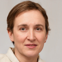 Joyful white adult female with medium  brown hair and grey eyes